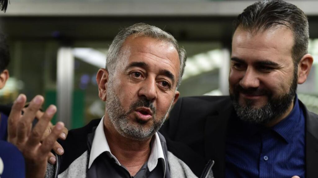 Osama Abdul Mohsen, the Syrian refugee who made world headlines when a Hungarian journalist tripped him over as he fled, addresses journalists next to the director of the Spanish football coaching school, Miguel Ángel Galán after arriving in Madrid. Photograph: Javier Soriano/AFP/Getty Images