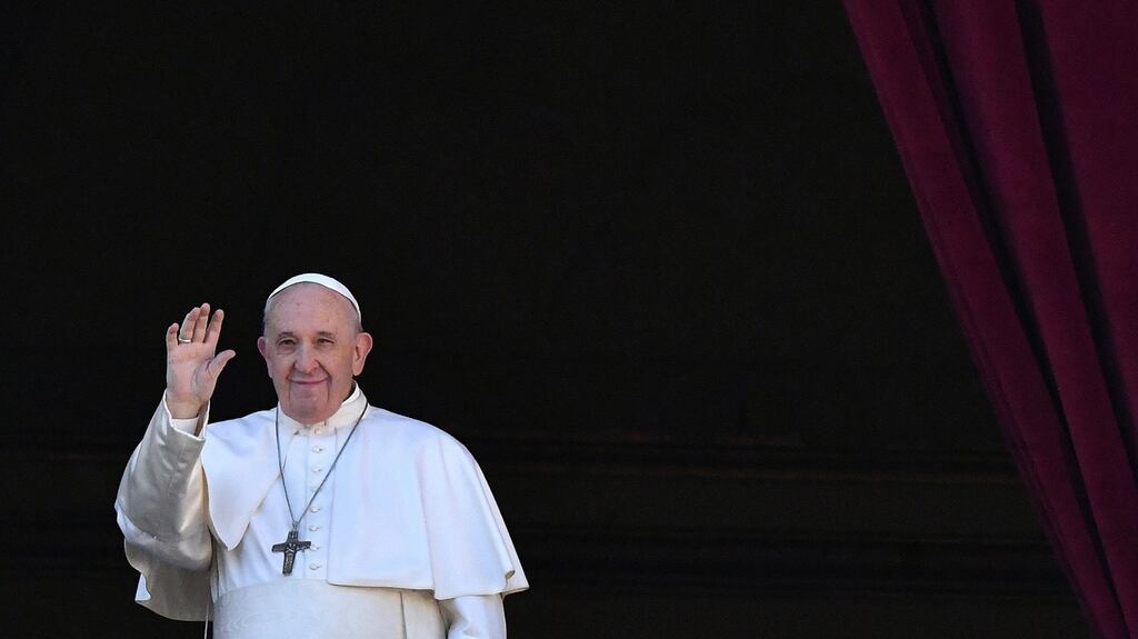 Pope Francis waves from the balcony of St Peter’s basilica during the traditional “Urbi et Orbi” Christmas message to the city and the world, at St Peter’s square in Vatican. (Photo by ALBERTO PIZZOLI/AFP via Getty Images)