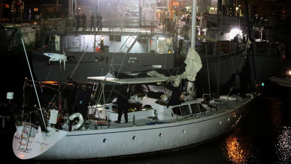 Customs officials aboard the yacht Makayabella at Haulbowline naval base in Cobh, Co Cork last night. Photograph: PA Wire.