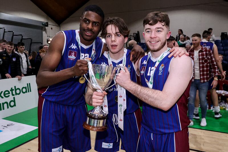 University of Galway Maree’s Mark Thiam, Comhghall McCormack and Matthew Sweeney celebrate with the Pat Duffy Cup at National Basketball Arena, Dublin. Photograph: Ben Brady/Inpho