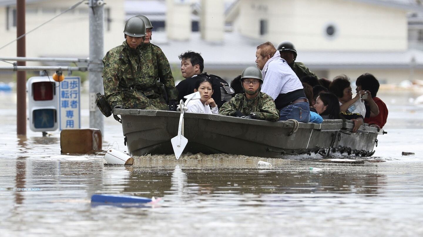 Residents are rescued from a flooded area by Japan Self-Defense Force soldiers in Kurashiki, southern Japan, on Saturday. Photograph: Reuters