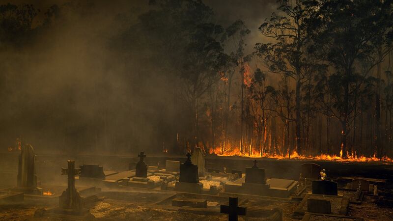 A wildfire approaches a cemetery in Conjola, Australia, on Tuesday. Photograph: Matthew Abbott/New York Times