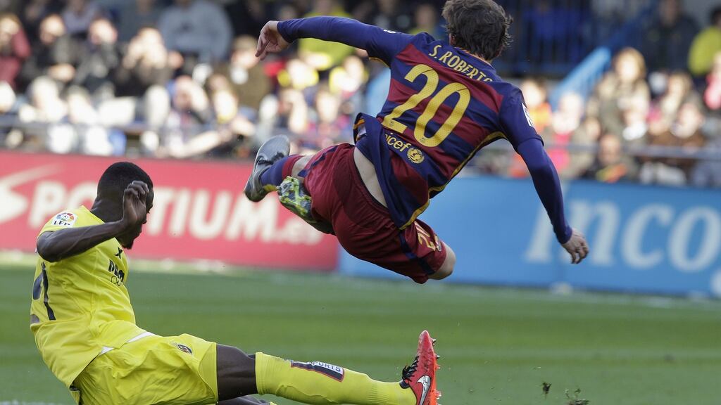 Barcelona’s Sergi Roberto falls past Villarreal’s Eric Bailly in action during their La Liga clash. Photo: Heino Kalis/Reuters