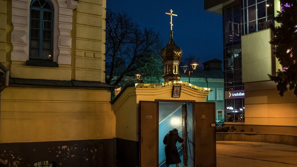 A worshiper enters the basement of the Church of the Archangel Michael in Rivne, Ukraine, where the Moscow-led Orthodox branch holds services. Photograph: Brendan Hoffman/New York Times