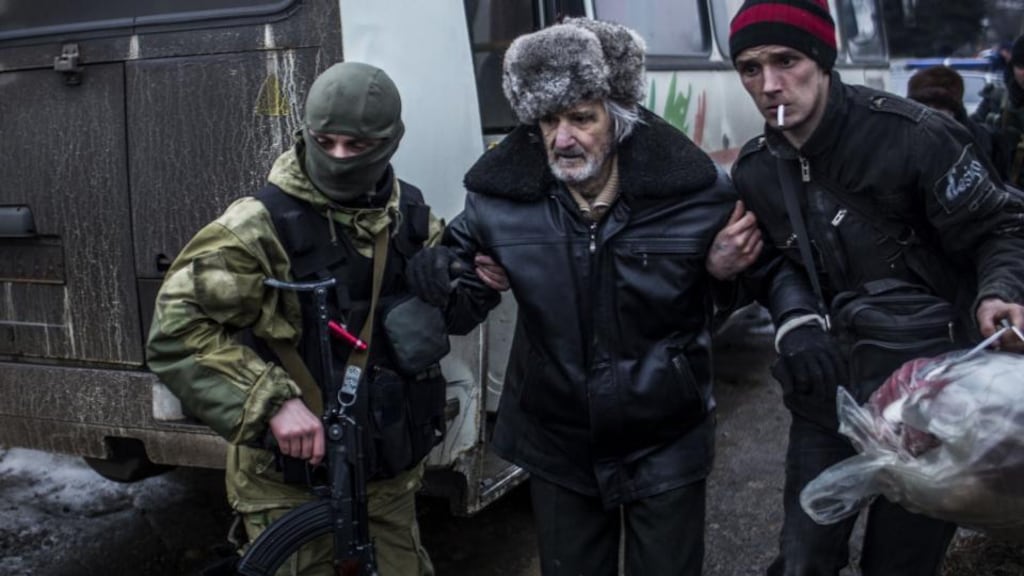 An elderly Ukrainian man is helped by a Ukrainian army soldier and a citizen during a evacuation of civilians from Debaltseve in the Donetsk region. Photograph: AFP Photo / Manu Brabomanu Brabo