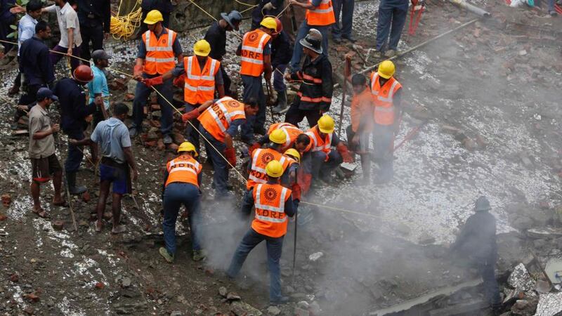 Rescue crews search for survivors at the site of a collapsed residential building in Mumbai, India. Photograph: Danish Siddiqui/Reuters