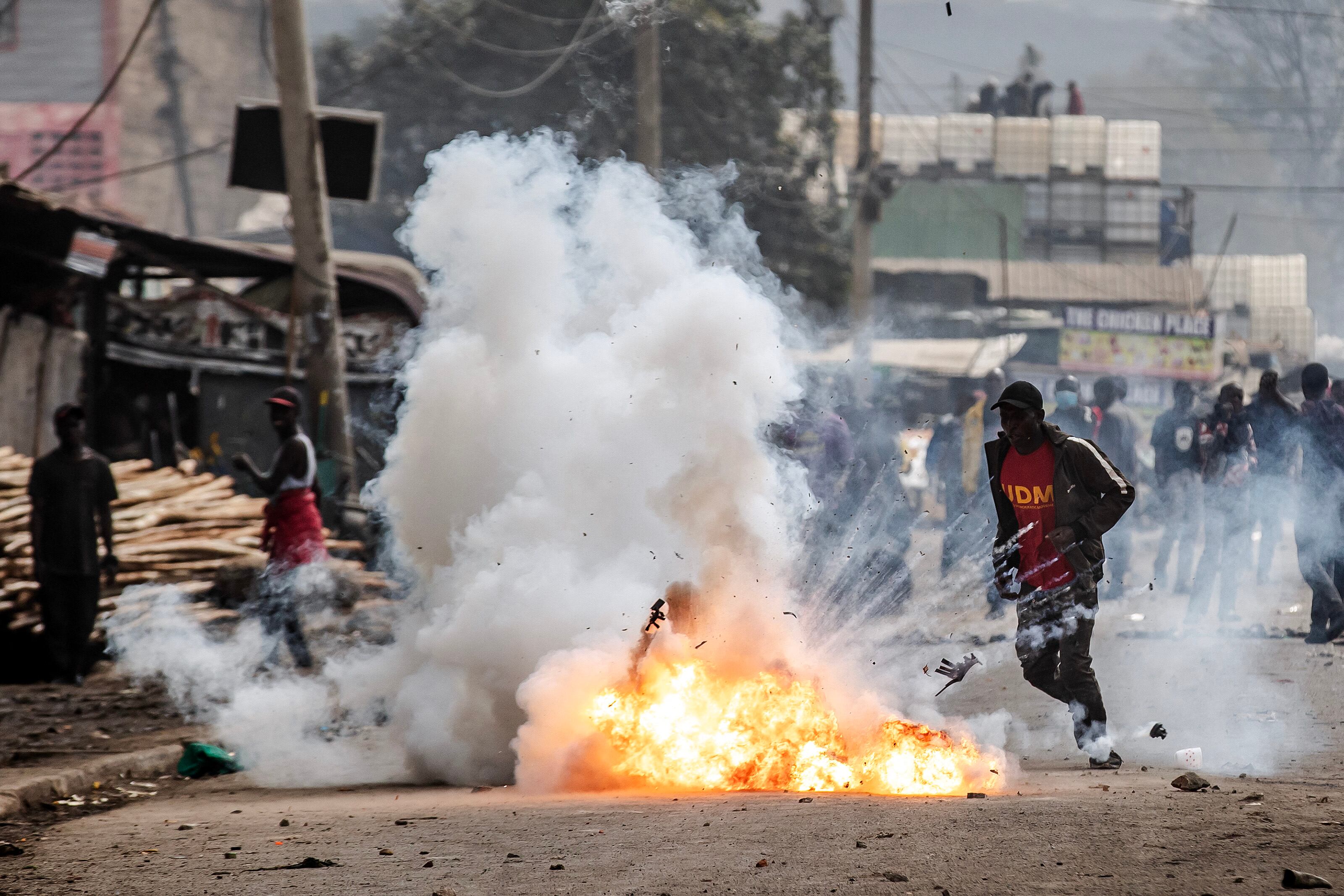 A Kenyan opposition supporter reacts as a teargas canister explodes in front of him during demonstrations with Kenya Police Officers in Nairobi, Kenya. Photograph: Luis Tato / AFP