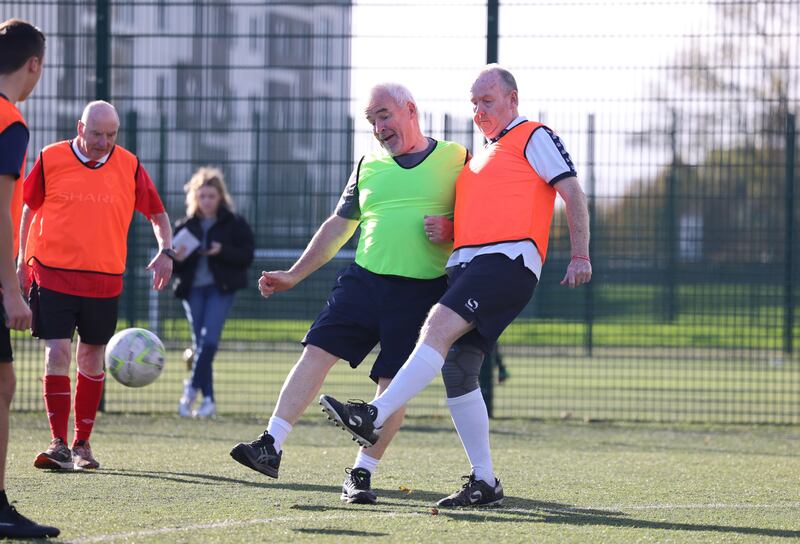 Stephen Harrison and Derek Reid vie for possession. Photograph: Dara Mac Dónaill