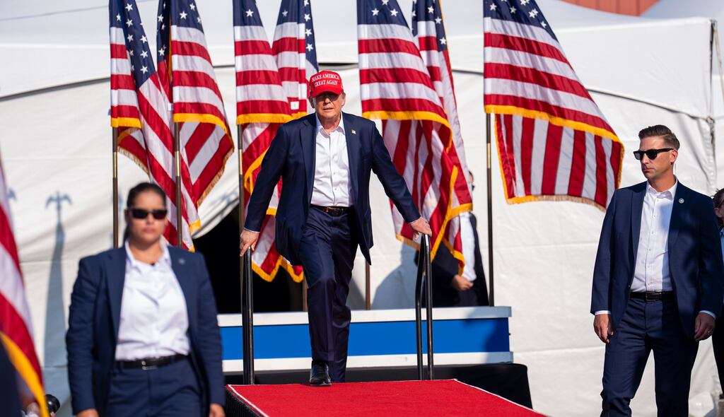 Secret Service agents flank former president Donald Trump as he walks to the stage shortly before the assassination attempt at a campaign rally in Butler on Saturday. Photograph: Doug Mills/The New York Times