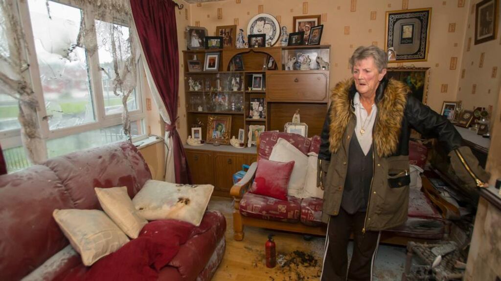 A file image from last week of Nellie Halligan, grandmother of the injured children, in the living room where a petrol bomb was thrown through a window. Photograph: Patrick Browne