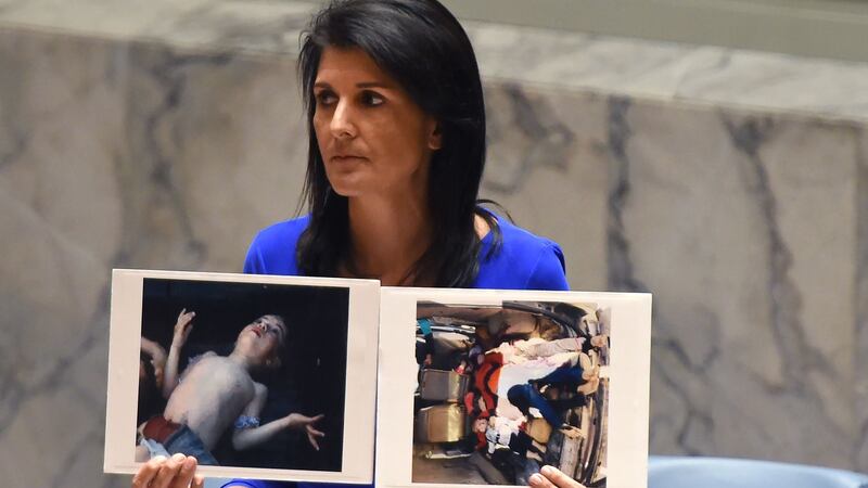 US ambassador to the UN Nikki Haley holds photos of victims of the chemical weapons attack in Syria at the UN Security Council last week. Photograph: Timothy A Clary/AFP/Getty Images
