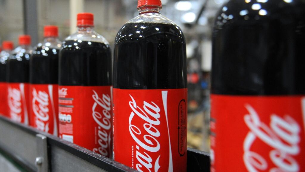 Bottled cola goods such as Coca Cola are getting cheaper in Ireland, new figures from Kantar show. (Photograph: REMY GABALDA/AFP/Getty Images)