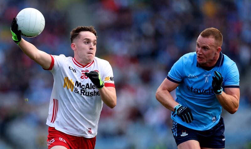Tyrone’s Eoin McElholm holds possession against Ciarán Kilkenny of Dublin. Photograph: James Crombie/Inpho