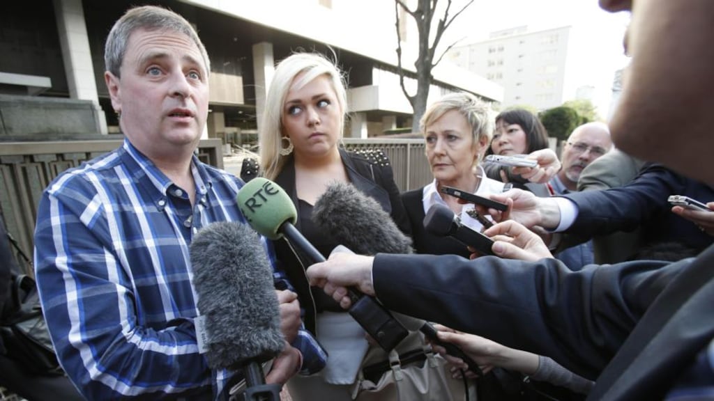 Andrew Furlong with his wife Angela and their daughter Andrea speaking to reporters outside Tokyo district court yesterday. Photograph: Koji Sasahara/AP