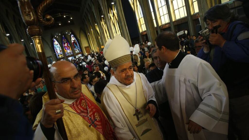 ‘Protesters accused Bishop Barros of having thwarted investigations into the actions of Fr Fernando Karadima, one of the best-known and most respected priests in Chile until a spate of serious allegations emerged against him about 10 years ago.’ Above, Msgr Juan Barros Madrid is escorted after being attacked by demonstrators during his appointment as Bishop of Osorno, at Cathedral of Osorno, Chile. Photograph: EPA/FELIPE TRUEBA