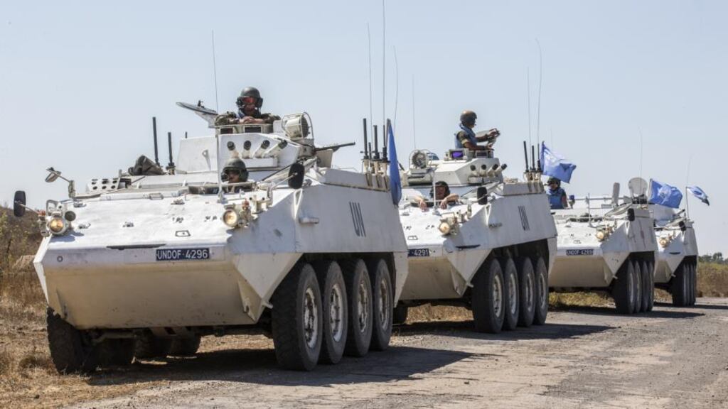 Irish members of the United Nations Disengagement Observer Force (Undof) sit on their armoured vehicles in the Golan Heights. Photograph: Jack Guez/AFP/Getty Images)