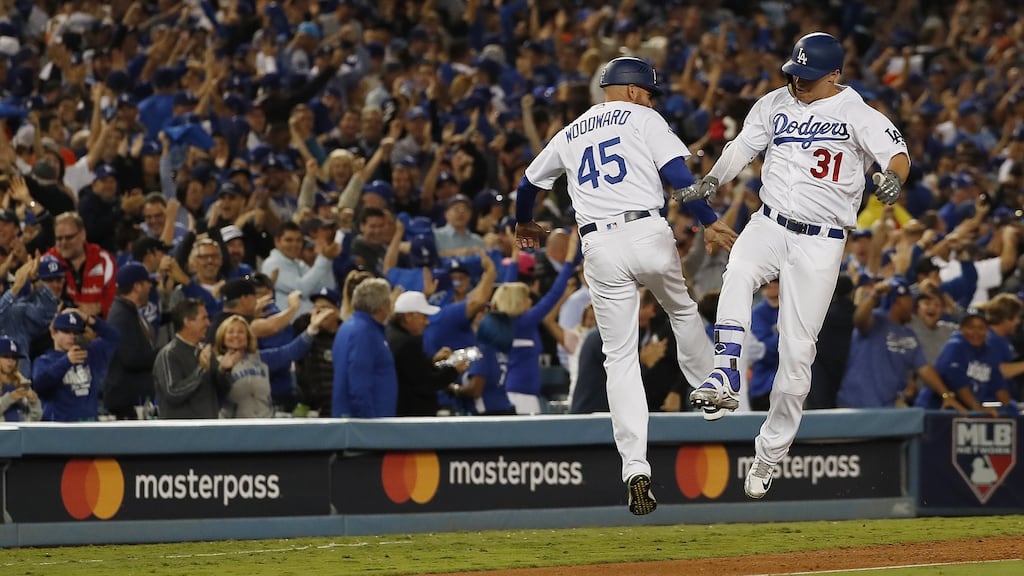 Los Angeles Dodgers batter Joc Pederson celebrates with third base coach Chris Woodward after hitting a solo home run against the Houston Astros in the bottom of the seventh inning of Major League Baseball’s World Series game six. Photograph: PA