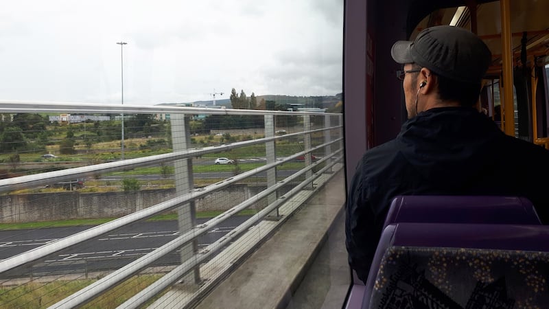 A passanger looks out from the Luas while travelling on the green line. Photograph: Aidan Crawley