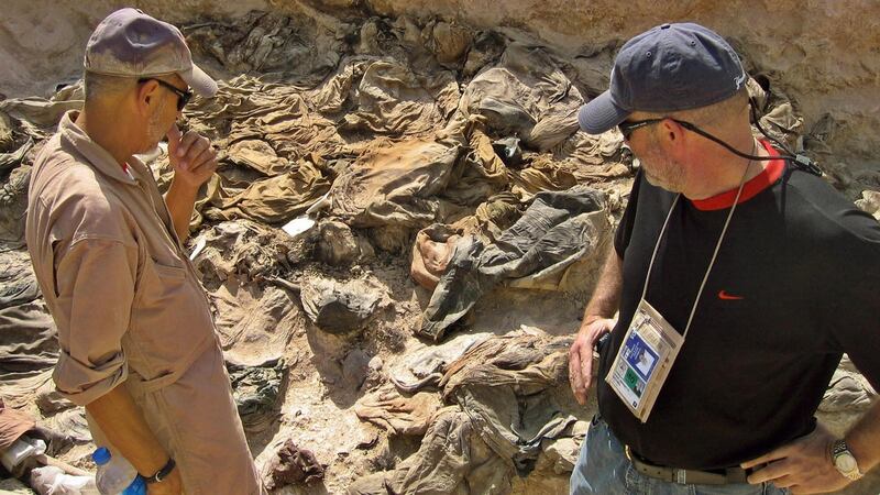 Archaeologist Michael Trimble and Greg Kehoe (right), a US lawyer appointed by the White House to work with the Iraqi Special Tribunal, view a mass grave site being excavated in the northern Iraqi town of Hatra in October 2004. Photograph: Thannasis Cambanis/AFP via Getty Images)