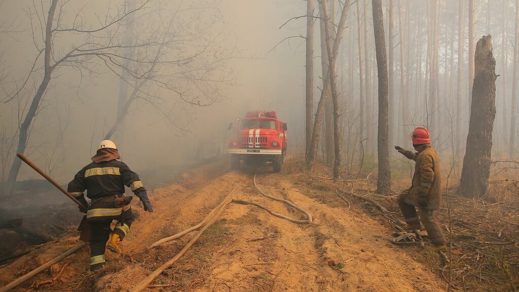 Ukrainian firemen fight with forest fire which burns near the village of Ragovka, close to the exclusion zone around the Chernobyl nuclear power plant. Photograph: EPA