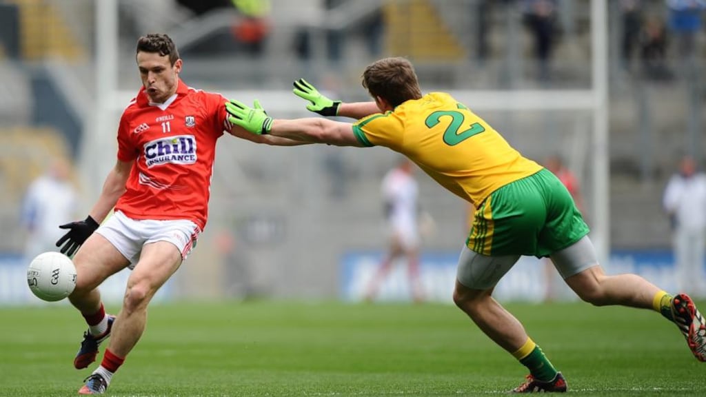 Donegal’s Hugh McFadden tries to block down Cork’s John O’Rourke. Photograph: Tommy Grealy/Inpho
