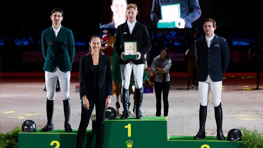 Darragh Kenny (R) on the podium with Steve Guerdat (L) and winner Marcus Ehning. Photograph: Alex Caparros/Getty