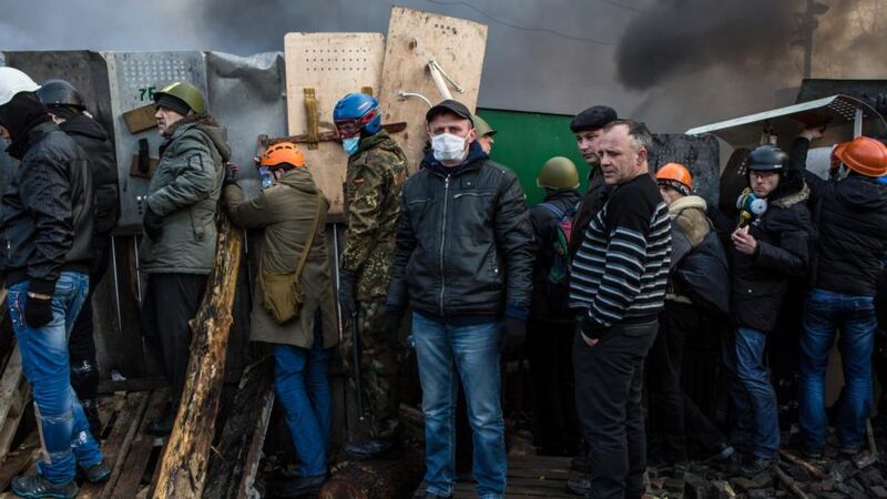 Anti-government protesters guard the perimeter of Independence Square in Kiev today. Photograph: Brendan Hoffman/Getty Images.
