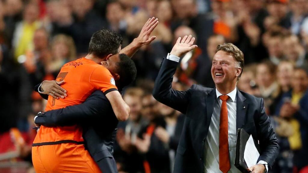 Robin van Persie of the Netherlands celebrates with coach Patrick Kluivert and manager Luis van Gaal after scoring their fourth goal during the World Cup Qualifing match against Hungary at Amsterdam Arena last year.