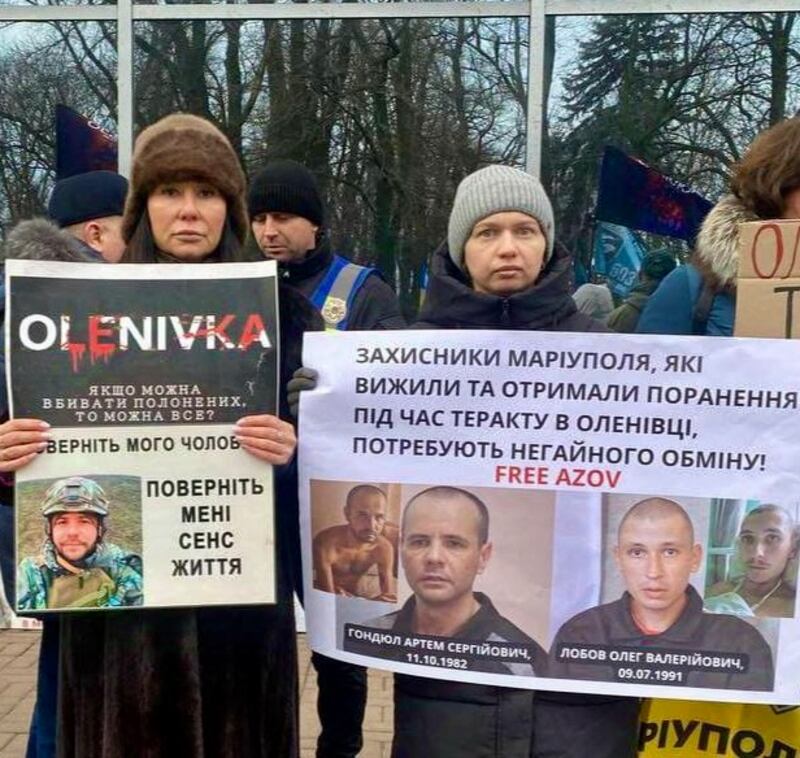Anastasiia Hondiul and Anna Lobova holding placards showing their husbands, Ukrainian soldiers Artem Hondiul and Oleh Lobov. The men survived Russia's attack on the port of Mariupol and the 80-day siege of its Azovstal steelworks and have been in Russian captivity since May 2022. Photograph courtesy of Anna Lobova