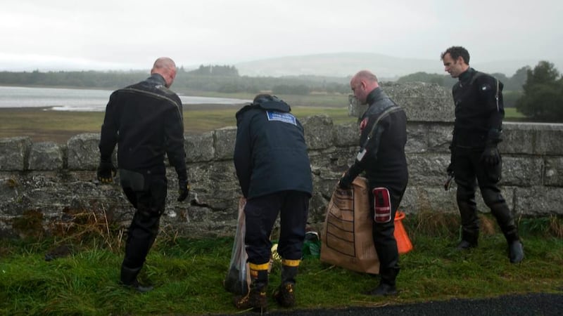 Members of the Garda water unit investigating the discovery of Elaine O’Hara’s remains recover items including a ruck sack from the resivuoir near Roundwood, Co Wicklow last month. Photograph: Garry O’Neill