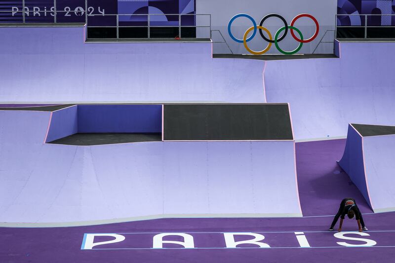 A worker places logos on the BMX venue at the La Concorde in Paris in advance of the Olympic Games. Photograph: David Gray/AFP via Getty Images