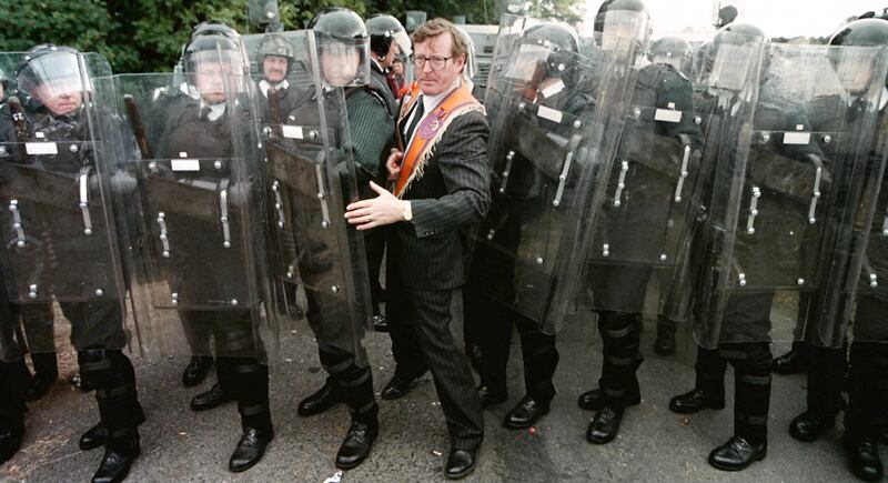 Then Ulster Unionist Party MP David Trimble squeezing through the RUC line after negotiations to prevent the stand-off at Drumcree Parish Church. Photograph: Brian Little/PA
