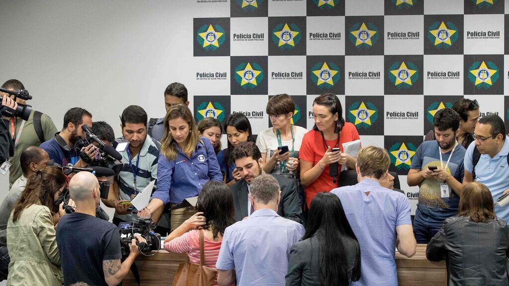 Journalists crowd around Rio police commissioner Aloysio Falcão (grey blazer, at centre) and a display of items related to the Rio 2016 Olympic Games ticketing investigation at the Civil Police Fraud Unit, Rio de Janeiro, August 17th, 2016. File photograph: Morgan Treacy/Inpho