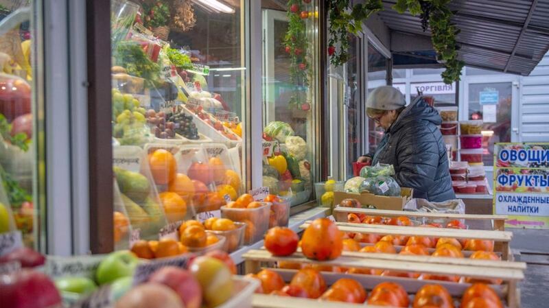 A woman buys vegetables in a shop in the second largest Ukrainian city of Kharkiv, located some 35km from Ukrainian-Russian border. Photograph: Sergey Bobok/AFP via Getty Images