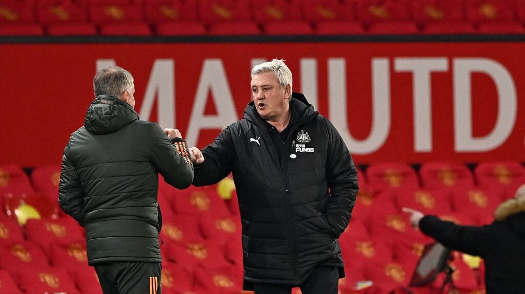 Newcastle United’s Steve Bruce bumps fists with Manchester United’s Ole Gunnar Solskjaer at the end of the Premier League match at Old Trafford. Photo: Stu Forster/AFP via Getty Images