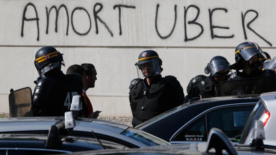 French riot police secure the Porte Maillot. The slogan reads ‘Death to Uber’. Photograph: Charles Platiau/Reuters