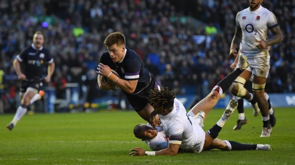 Huw Jones the third Scotland try under pressure from Anthony Watson and Mike Brown. Photograph: Shaun Botterill/Getty Images