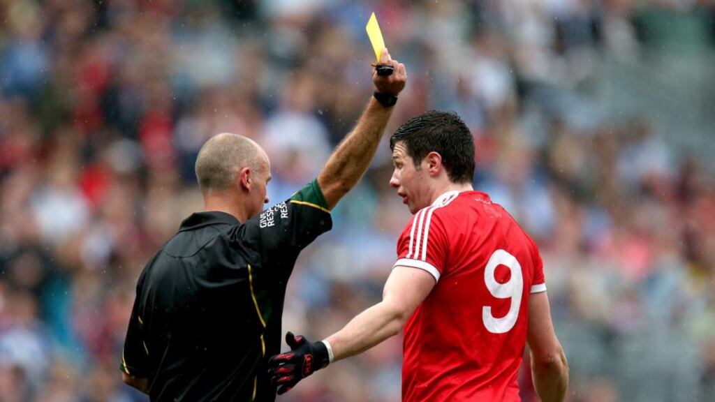 Tyrone’s Seán Cavanagh is yellow carded by referee Cormac Reilly at Croke Park. Photograph: Ryan Byrne/Inpho