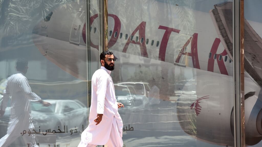 A man walks past the Qatar Airways office in Riyadh, Saudi Arabia, on Monday. Photograph: Fayez Nureldine/AFP/Getty Images
