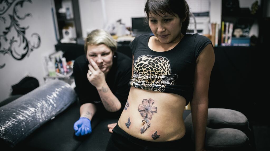 After being stabbed by her husband, Laysan receives a tattoo to cover the scar in Evguenia Zakhar’s tattoo studio in Ufa, Russia