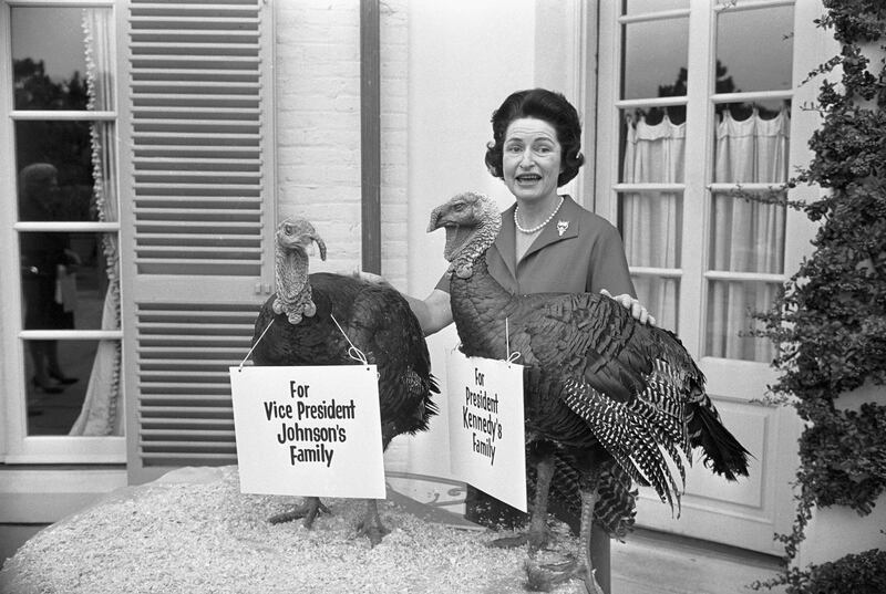 Lady Bird Johnson poses with two 40lb Thanksgiving turkeys gifted to her family and president John F Kennedy's family in 1962. Photograph: Bettmann Archive