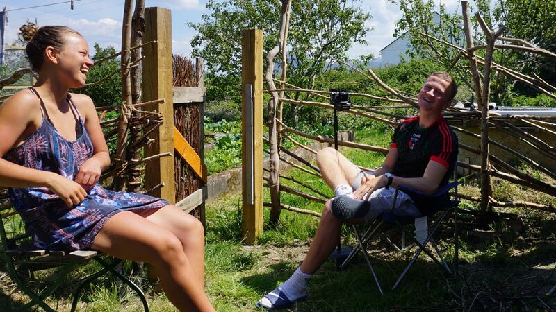 Sandy O’Callaghan tells the story to his sister Maebh in the vegetable garden in Connemara, June 2020