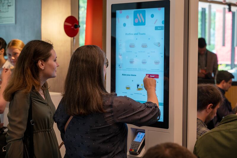 Visitors order food on touchscreens at the newly-opened fast-food outlet. Photograph: Dmitry Serebryakov/AP
