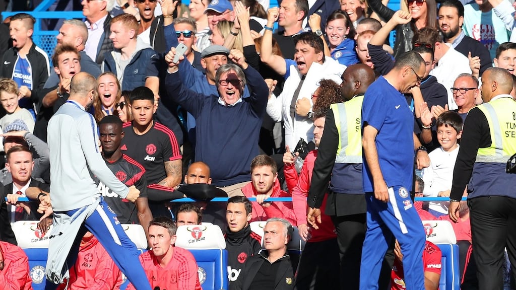A member of the backroom staff at Chelsea celebrates his side’s second goal infront of Manchester United manager José Mourinho. Photo: Catherine Ivill/Getty Images