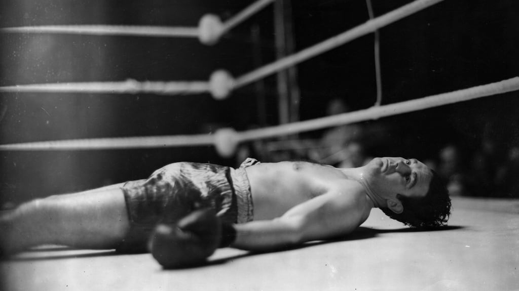 Doyle on the ring floor after being knocked down in the first round of his fight against Eddie Phillips at White City, London in 1939. Photograph: Topical Press Agency/Getty Images