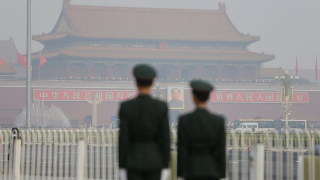 Paramilitary police officers stand guard near Tiananmen Gate on a hazy day in Beijing. Photograph: Jason Lee/Reuters