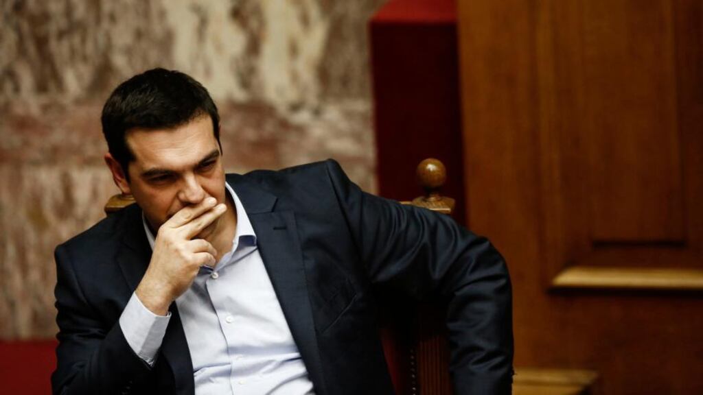 Greece’s prime minister Alexis Tsipras listens in parliament to a speech by his predecessor, Antonis Samaras, who was in Brussels this week, where he discussed the continuing Greek crisis with European Commission president Jean-Claude Juncker. Photograph: Kostas Tsironis/Bloomberg