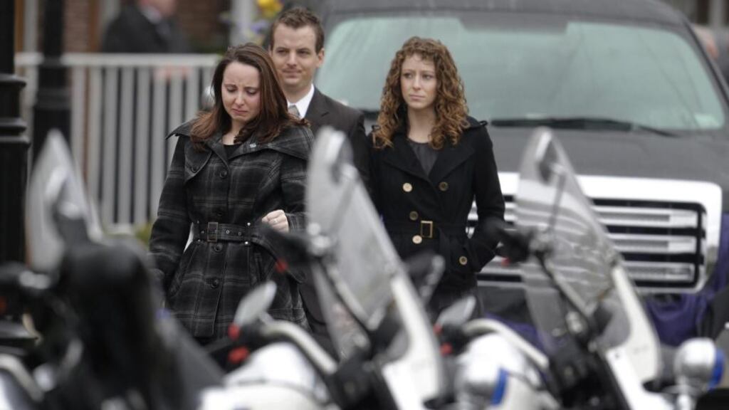 Mourners walk past police motorcycles as they depart St. Patrick’s Church in Stoneham, Mass., following a funeral Mass for Massachusetts Institute of Technology police officer Sean Collier on Tuesday. Photograph: AP