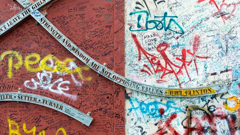 Part of the “peace wall” that separates Catholic and Protestant areas in Belfast, with a quotation attributed to Bill Clinton, which reads “Strength and wisdom are not opposing values”. Photograph: Gety Images