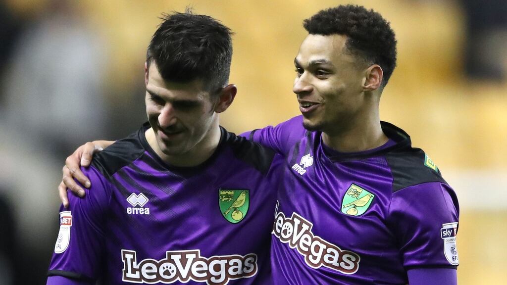 Norwich City goalscorer Nelson Oliveira (left) gets a hug from Josh Murphy at the end of the Championship match against Wolves at Molineux. Photograph: Nick Potts/PA Wire